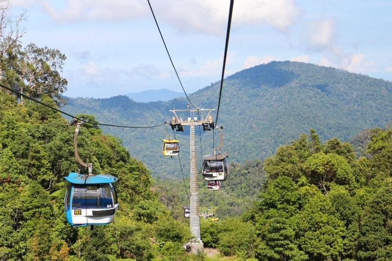 Kereta gantung Awana SkyWay melewati perbukitan hijau berkabut di Genting Highlands